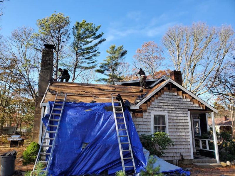 A newly installed asphalt-shingle roof on a modern coastal home